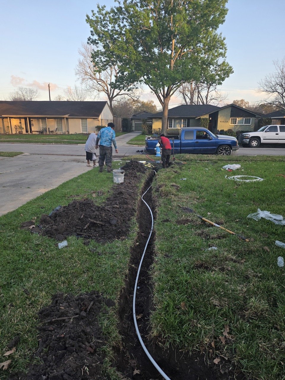 Houston plumber inspecting drain and P-trap under bathroom sink for sewer gas odor