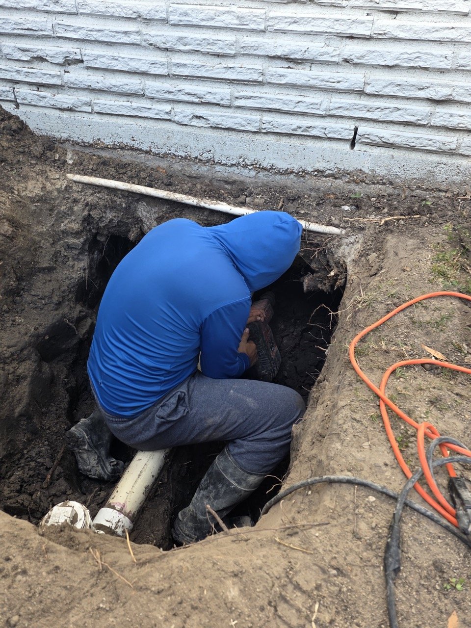 Plumber installing drain pipes correctly with proper angle and slope in a Houston home